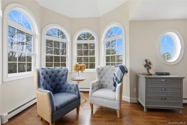 a living room with furniture and two windows