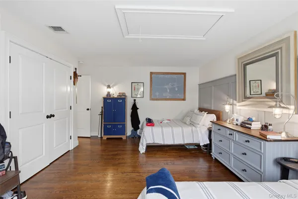 a bedroom with furniture and wooden floor