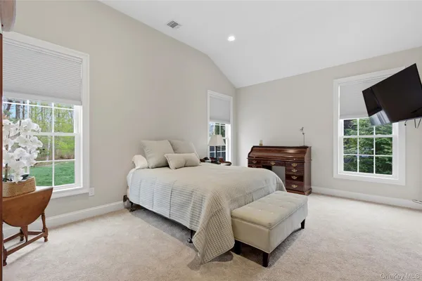 a spacious bedroom with a bed and a window