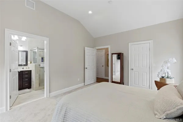a bedroom with a bed and a mirror