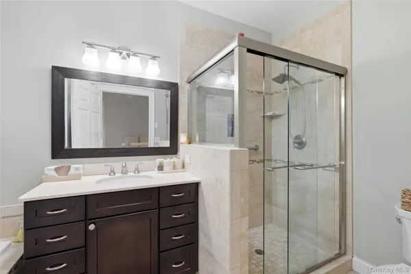 a bathroom with a sink vanity and a mirror