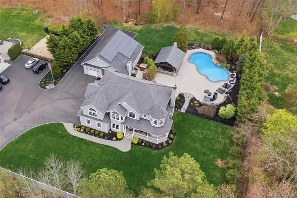 an aerial view of a house with garden space and street view