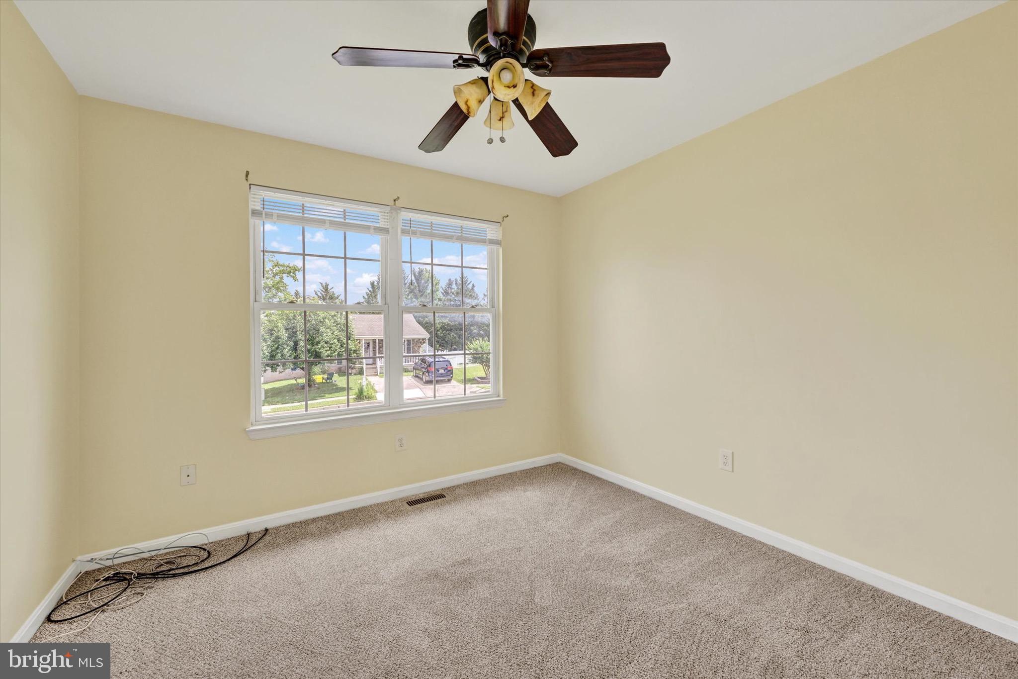 21 Box Circle Baltimore, MD 21221 - Photo 9 of 23 en empty room with windows and chandelier fan