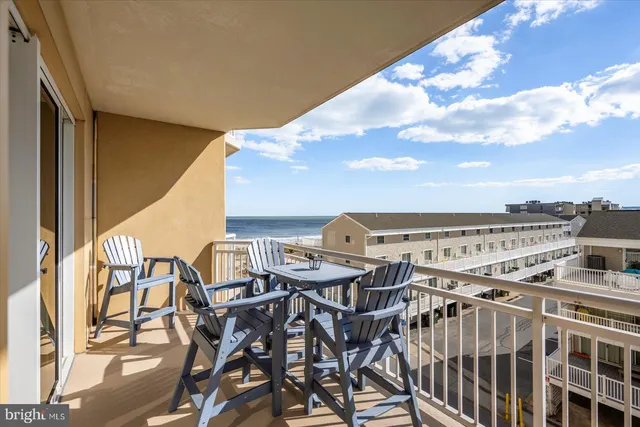 a kitchen with kitchen island granite countertop a table and chairs in it