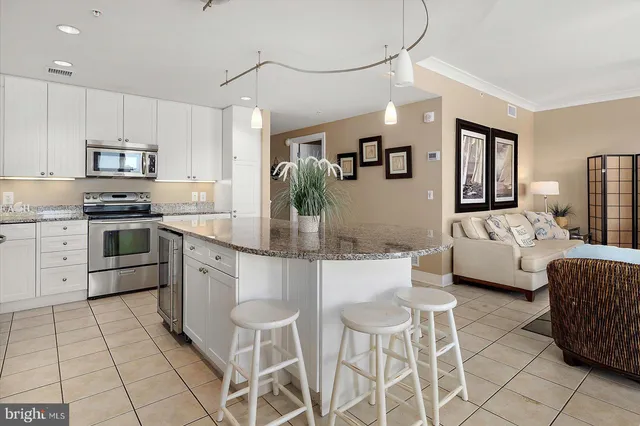 a bathroom with a granite countertop sink a mirror and a shower