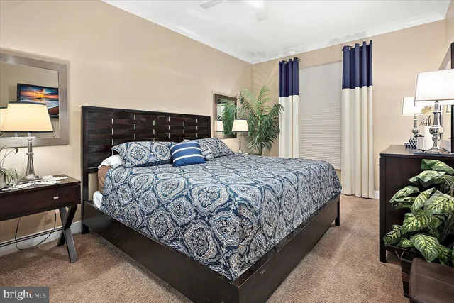 a bedroom with two beds and a desk