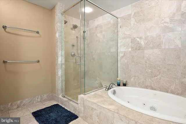 a living room with furniture a flat screen tv and large windows