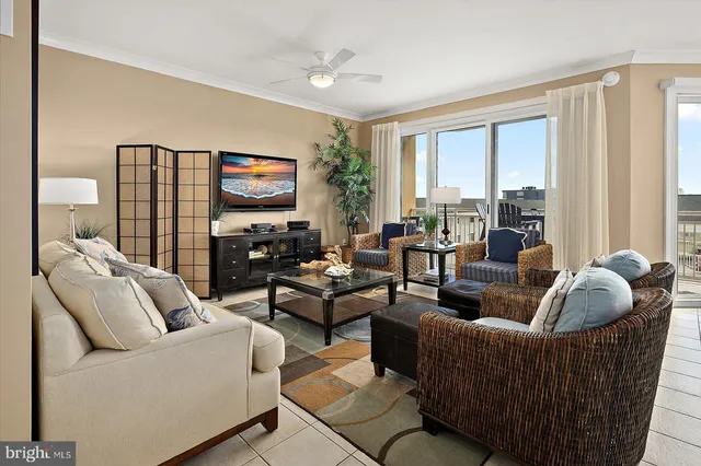 a living room with furniture and large windows