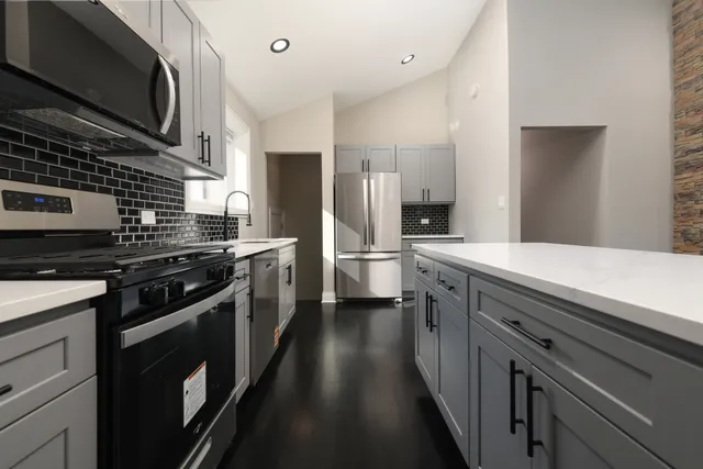 a kitchen with a sink stove and refrigerator