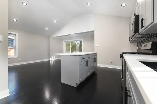 a kitchen with sink and cabinets