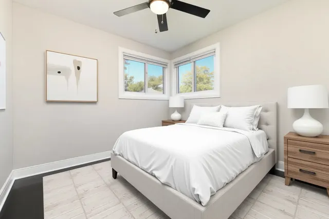 a large bed sitting in a bedroom next to a window