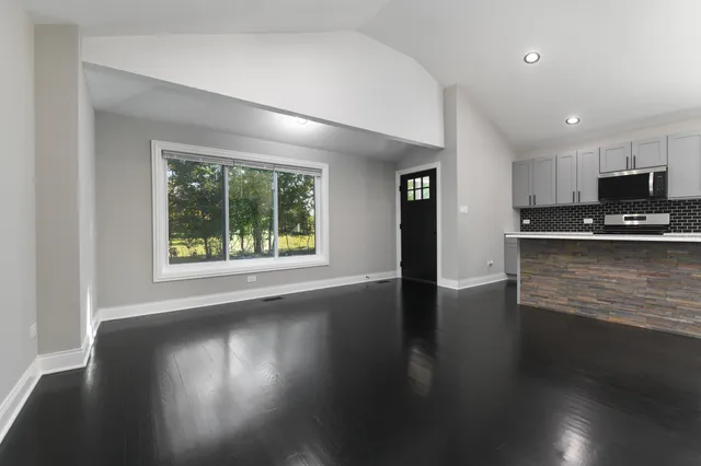 a view of kitchen with granite countertop cabinets and a sink