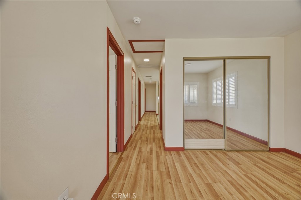 13407 Kagel Canyon Road Sylmar, CA 91342 - Photo 11 of 31 a view of a hallway with wooden floor and closet