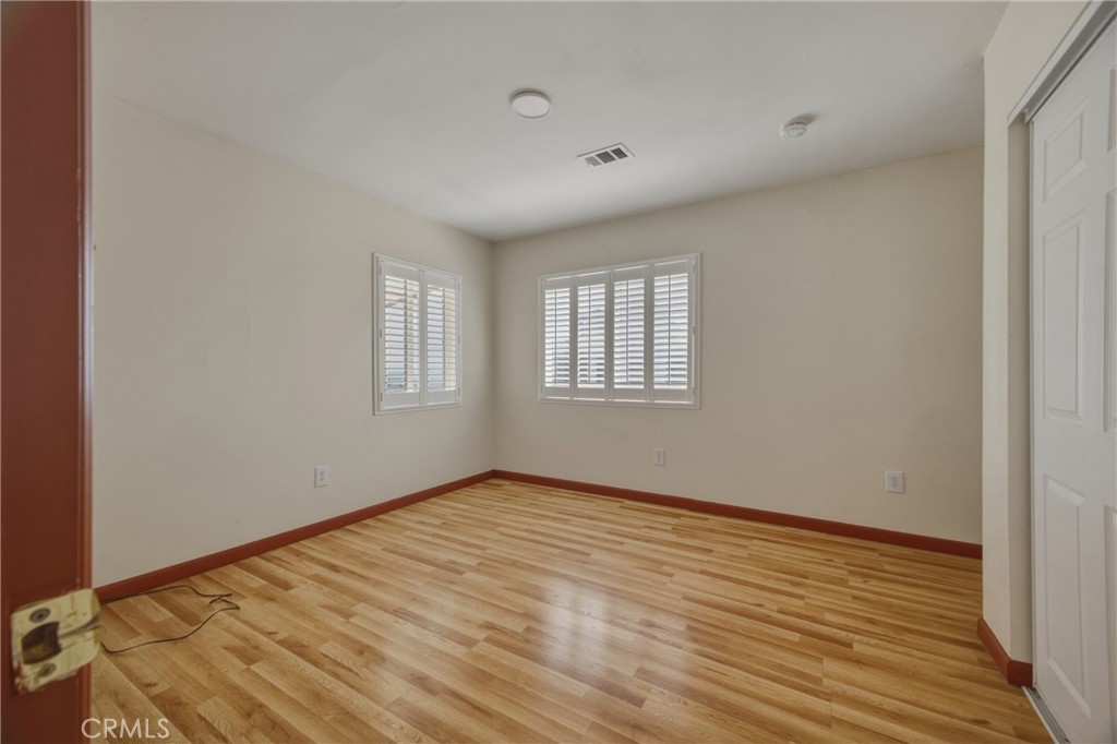13407 Kagel Canyon Road Sylmar, CA 91342 - Photo 14 of 31 a view of an empty room with wooden floor and a window