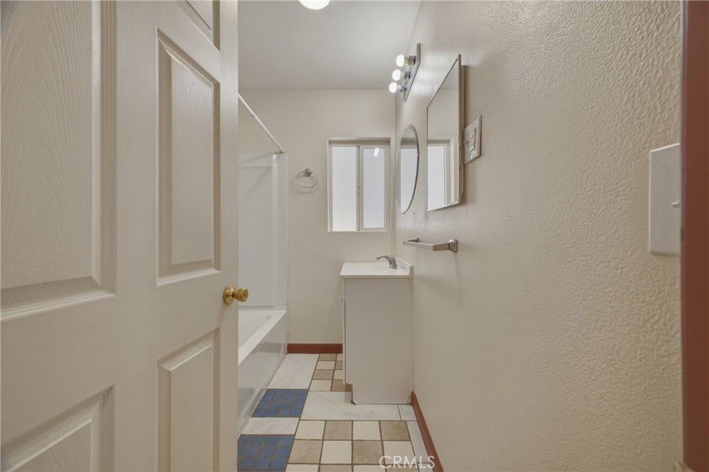 13407 Kagel Canyon Road Sylmar, CA 91342 - Photo 17 of 31 a bathroom with a sink a toilet a mirror and shower
