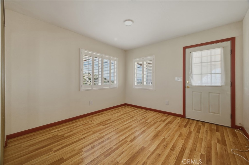 13407 Kagel Canyon Road Sylmar, CA 91342 - Photo 19 of 31 an empty room with wooden floor and windows