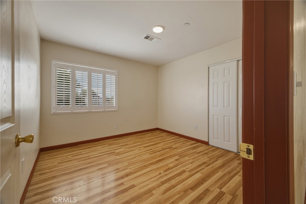 13407 Kagel Canyon Road Sylmar, CA 91342 - Photo 22 of 31 a view of an empty room with wooden floor and a window
