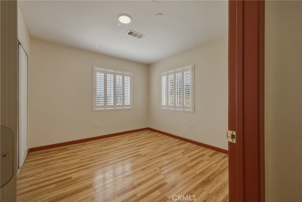 13407 Kagel Canyon Road Sylmar, CA 91342 - Photo 25 of 31 an empty room with wooden floor and windows