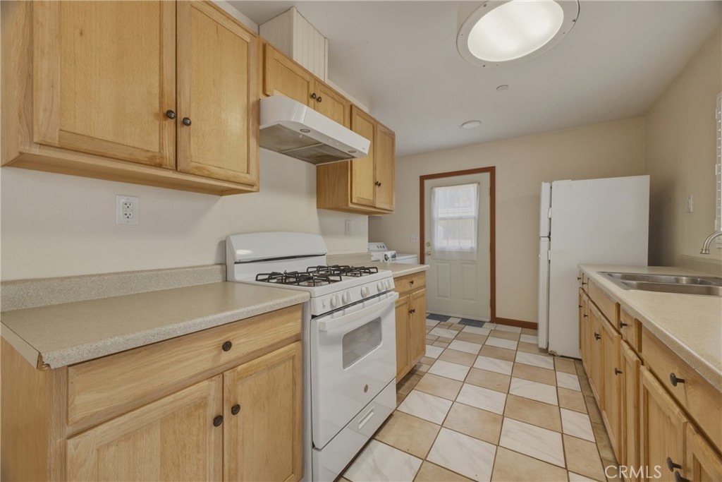 13407 Kagel Canyon Road Sylmar, CA 91342 - Photo 27 of 31 a kitchen with stainless steel appliances granite countertop a stove a sink and a white cabinets
