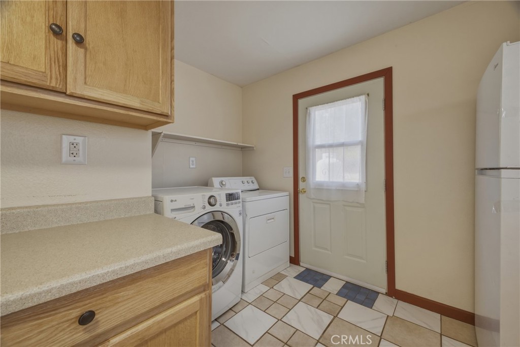 13407 Kagel Canyon Road Sylmar, CA 91342 - Photo 28 of 31 a utility room with cabinets washer and dryer
