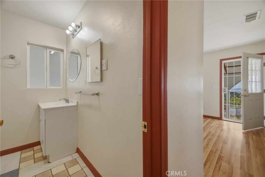 13407 Kagel Canyon Road Sylmar, CA 91342 - Photo 31 of 31 a bathroom with a sink a mirror and shower