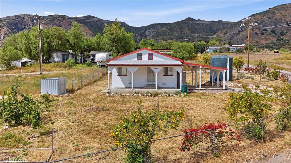 13407 Kagel Canyon Road Sylmar, CA 91342 - Photo 4 of 31 a view of a house with a yard and a large tree