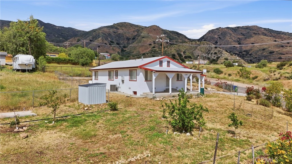 13407 Kagel Canyon Road Sylmar, CA 91342 - Photo 5 of 31 a front view of a house with a yard and mountain view