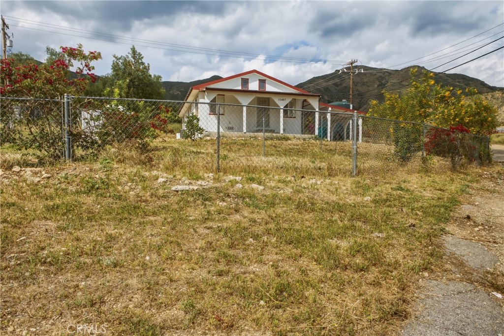 13407 Kagel Canyon Road Sylmar, CA 91342 - Photo 7 of 31 a view of a large house with a yard and wooden fence