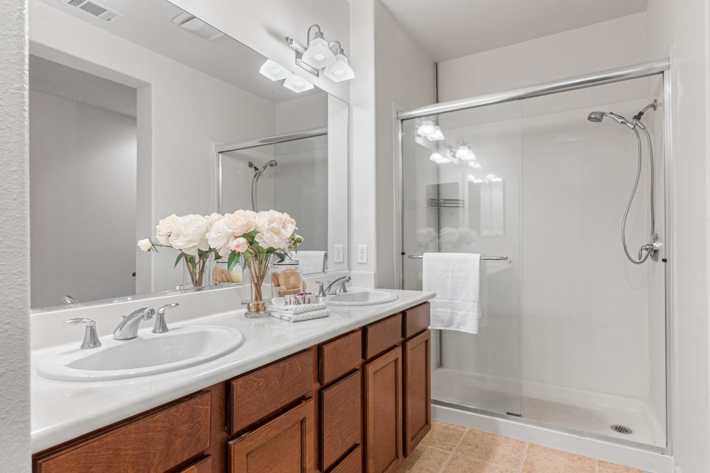 2197 Beech Circle San Jose, CA 95131 - Photo 21 of 32 a bathroom with a double vanity sink mirror and shower
