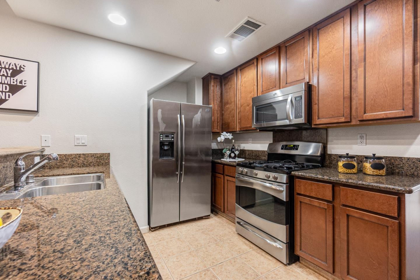 2197 Beech Circle San Jose, CA 95131 - Photo 8 of 32 a kitchen with stainless steel appliances granite countertop a stove a refrigerator and a sink