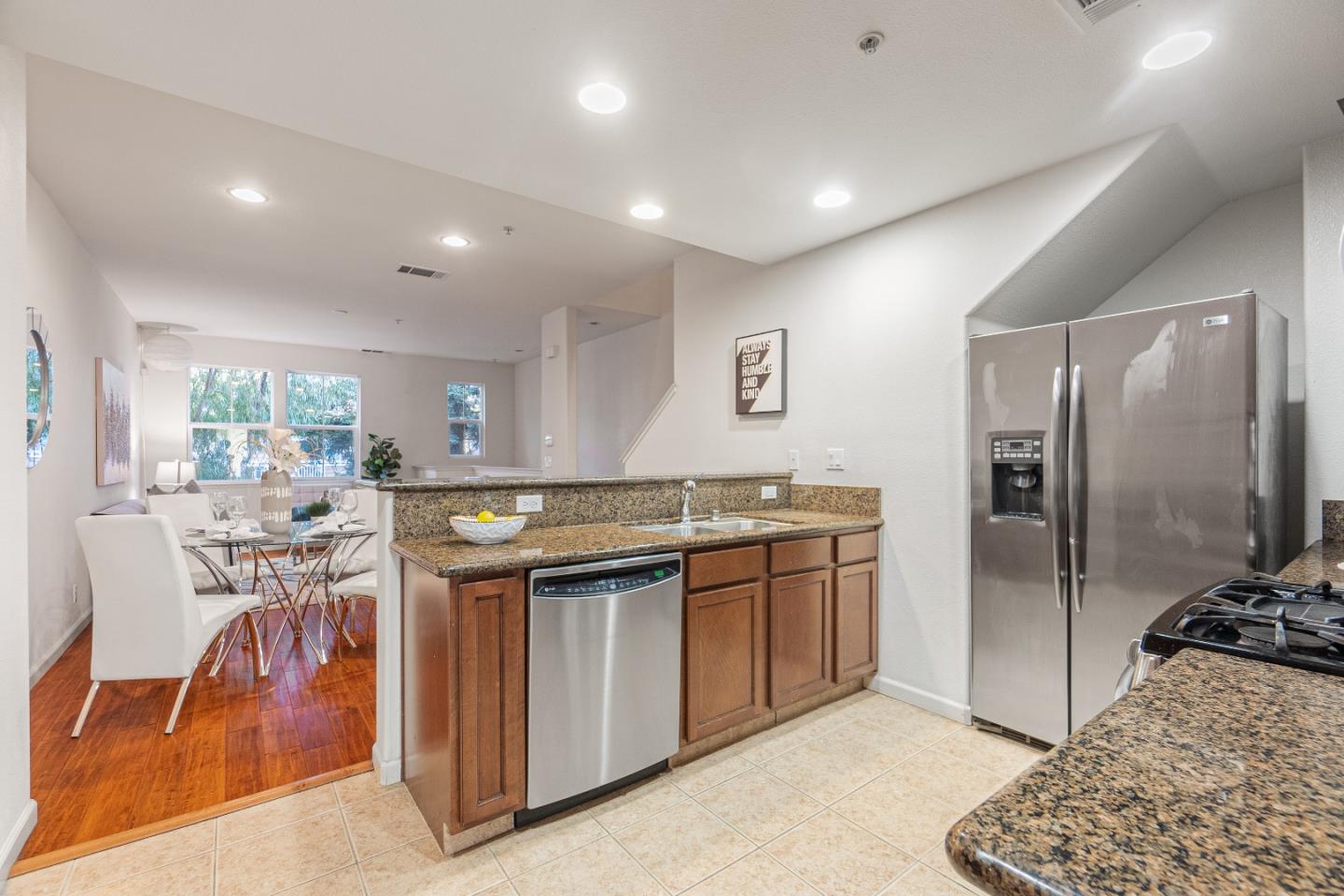 2197 Beech Circle San Jose, CA 95131 - Photo 9 of 32 a kitchen with stainless steel appliances kitchen island granite countertop a stove and a refrigerator
