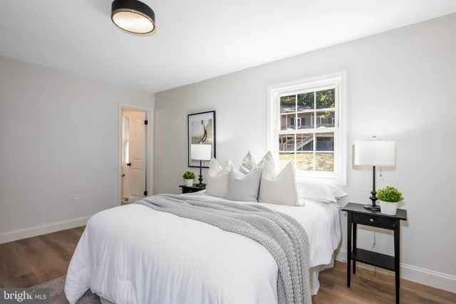 a bedroom with a bed and a potted plant