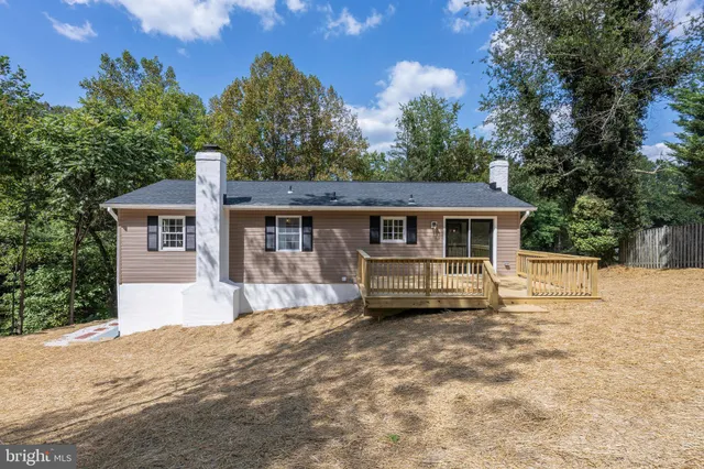 a front view of a house with a yard covered in snow