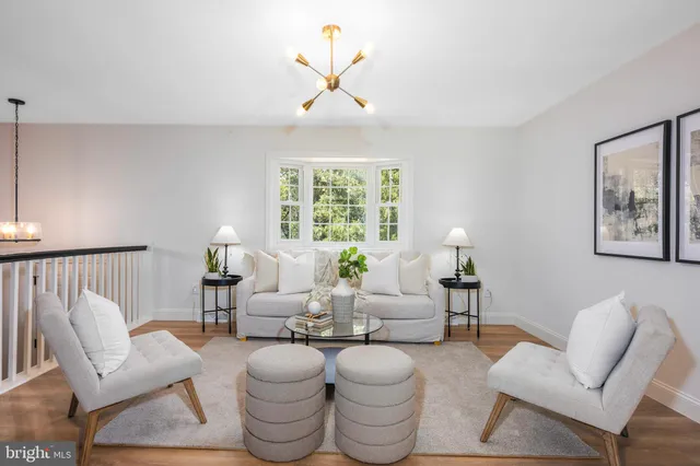 a living room with furniture a lamp and a large window