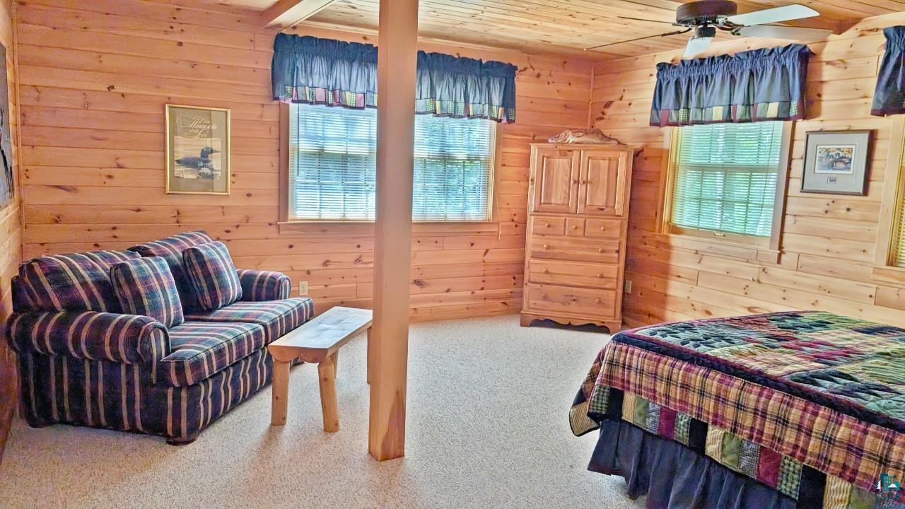 2357 Retreat Lodge Road Cook, MN 55723 - Photo 29 of 60 Carpeted bedroom featuring wood walls and wood ceiling