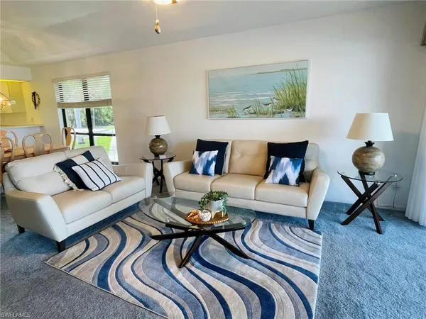 a living room with furniture and a rug