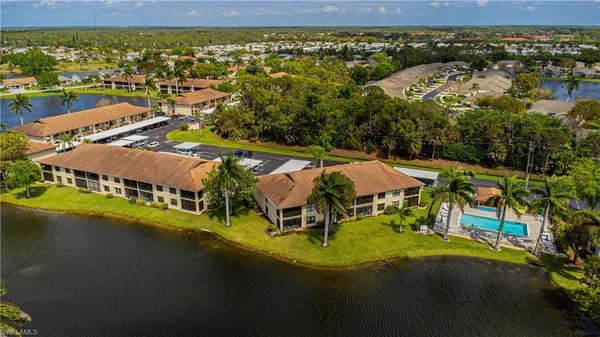 an aerial view of residential houses with outdoor space and swimming pool
