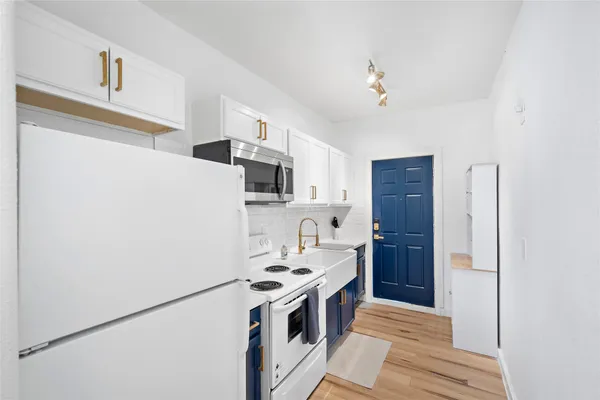 a kitchen with stainless steel appliances a refrigerator and a stove