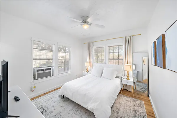 a bedroom with a large bed and a window