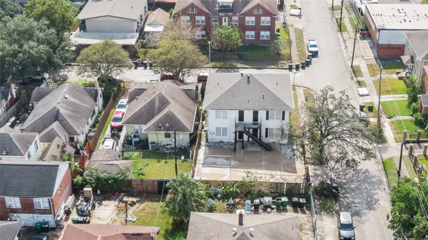 an aerial view of a house with a yard table and chairs