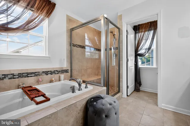a bathroom with a tub sink and mirror