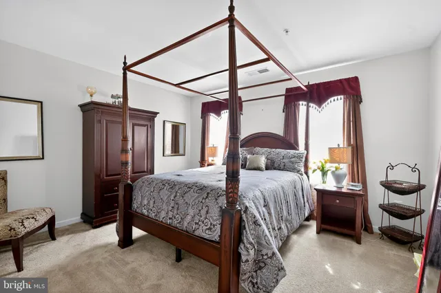 a bedroom with a bed next to a window