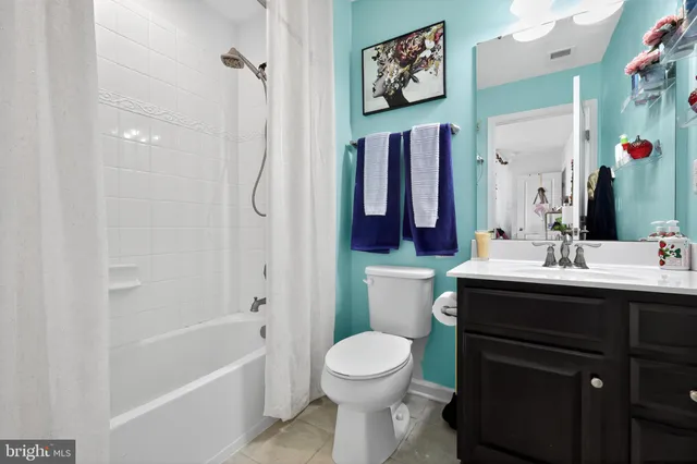 a bathroom with a sink vanity mirror and toilet