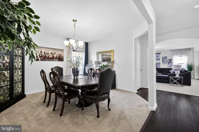 a view of a dining room with furniture wooden floor and chandelier