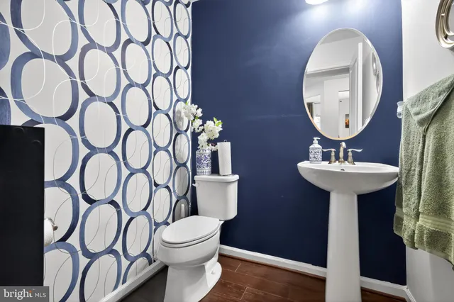 a bathroom with a toilet sink and mirror