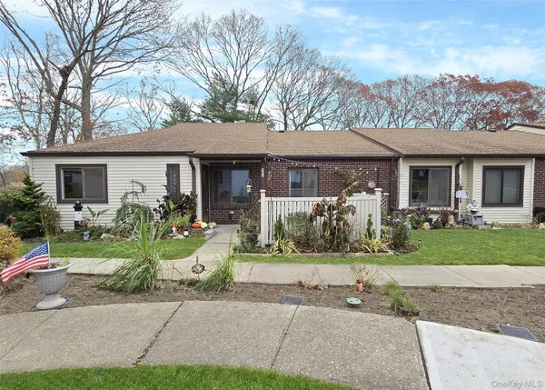 a front view of a house with garden and porch