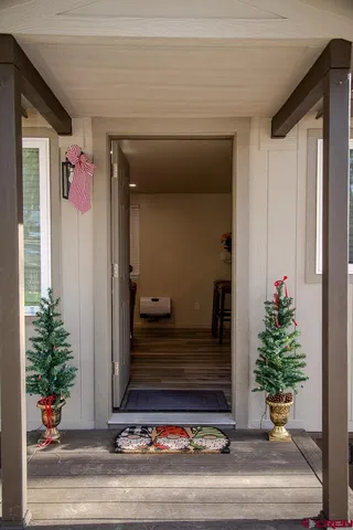 a large bed sitting in a bedroom next to a window and a wooden chair