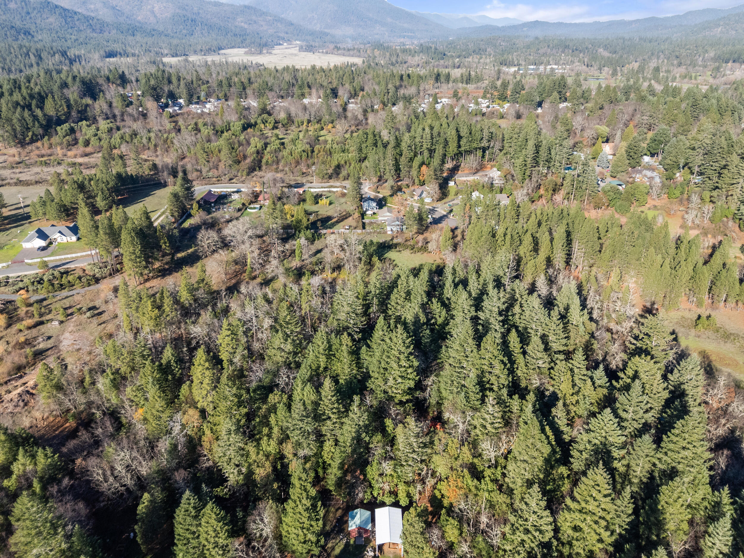 681 Daisy Hill Road Cave Junction, OR 97523 - Photo 12 of 26 a view of a city with lush green forest