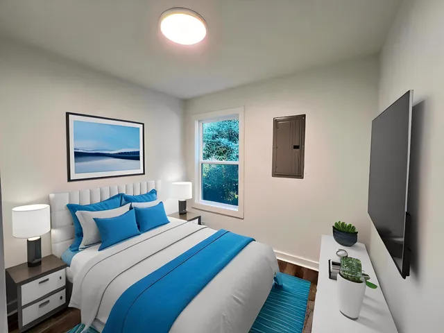 a bedroom with a bed and a window