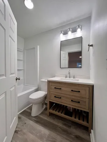 a bathroom with a toilet sink and mirror